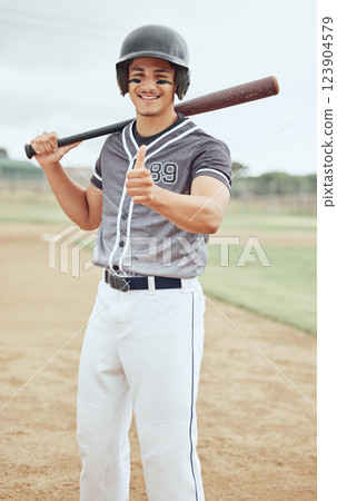 Baseball player, thumbs up and success for sports game on stadium pitch, field and arena for competition match. Portrait, smile and happy softball man with baseball bat, fitness helmet or winner hand 123904579