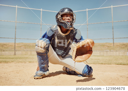 Baseball, sports and man waiting on a field during a game, competition or training. Athlete catcher playing a sport with focus for exercise and fitness in nature or a park at an event in summer 123904678