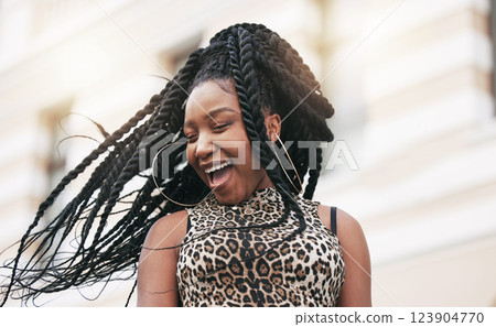 Hair, freedom and fashion with a fun black woman in the city on a summer day feeling cheerful or carefree. Braids, free and trendy with a young female in town on an urban background with flare 123904770