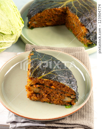 Chou farci, stuffed savoy cabbage pie with lentil quinoa ragu 123904774