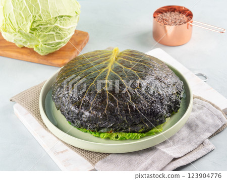 Chou farci, stuffed savoy cabbage pie with lentil quinoa ragu 123904776