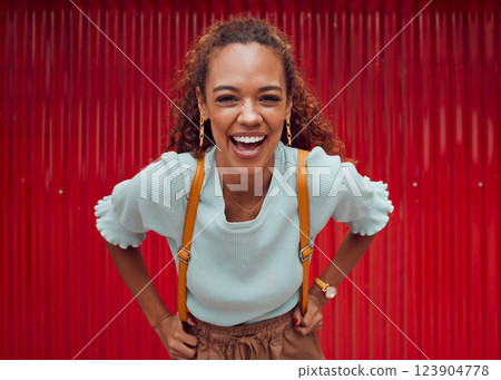 Woman, happy and freedom fashion, smile and outdoor fun on the weekend alone. Portrait of a young female laugh, fashionable and feeling confident while spending her free time on a red background 123904778