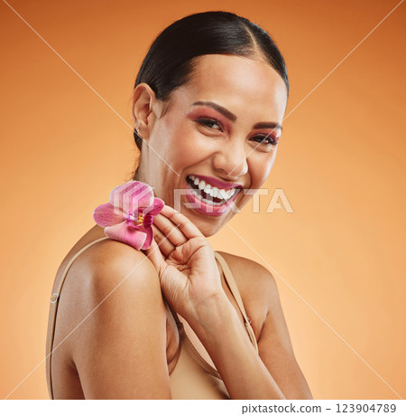 Skincare, beauty and flower with a model black woman in studio on an orange background to promote a natural product. Cosmetics, face and plant with an attractive young female posing for wellness Skincare, beauty and flower with a model black woman in studio on an orange background to promote a natural product. Cosmetics, face and plant with an attractive young female posing for wellness 123904789