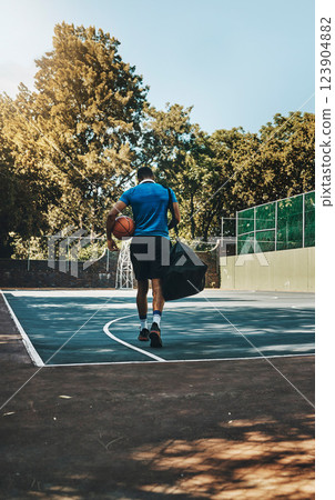 Basketball player, fitness training athlete and walk with equipment on outdoor court. African American sports man, healthy ball exercise motivation and athletic lifestyle workout on city field Basketball player, fitness training athlete and walk with equipment on outdoor court. African American sports man, healthy ball exercise motivation and athletic lifestyle workout on city field 123904882