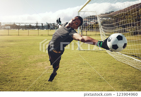 Soccer, sports and goalkeeper training on a field for a professional competition. Young and strong athlete with energy and motivation catching a football during a game or exercise on a sport ground Soccer, sports and goalkeeper training on a field for a professional competition. Young and strong athlete with energy and motivation catching a football during a game or exercise on a sport ground 123904960