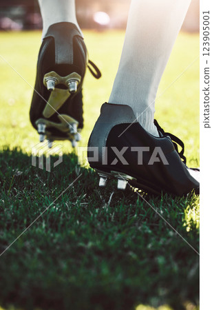 Soccer shoes, soccer player and soccer field by man for training, exercise and sports game. Football field, feet and football player shoe closeup with athletic guy walking getting ready for match 123905001