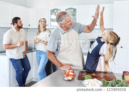 High five, happy family and cooking together success in kitchen bonding activity. Parents smile, senior man teach kid to make healthy lunch and good job child development through learning at home 123905038