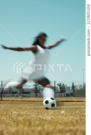 Motion blur soccer woman kick ball on stadium field, grass and sports competition game to score goals, winning and fitness. Female football athlete action, energy and dynamic shot in outdoor training 123905108