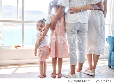 Women, children and generations, rear view at window, back legs and toddler girl looking with smile. Love, support and happy family together in holiday home in Sydney, Australia on first vacation day 123905134