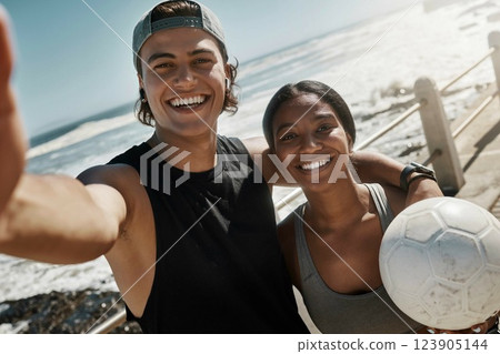 Selfie, friends and soccer for exercise by beach, for training and wellness with ball, smile and happy outdoor. Workout, man and healthy woman being relax, fitness and cheerful for health or football Selfie, friends and soccer for exercise by beach, for training and wellness with ball, smile and happy outdoor. Workout, man and healthy woman being relax, fitness and cheerful for health or football 123905144