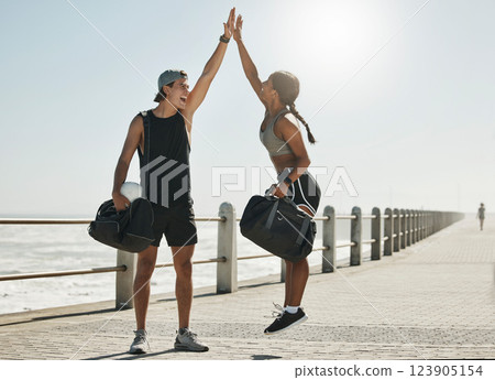 Motivation, high five and support with couple and fitness training for health, workout and goals in outdoor. Success, winner and partnership with man and woman jump for exercise, wellness and sports 123905154