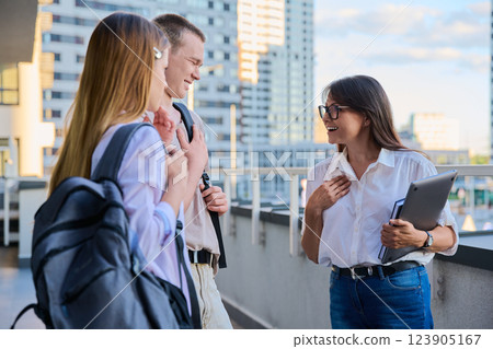 Group of college students talking with female teacher Group of college students talking with female teacher 123905167