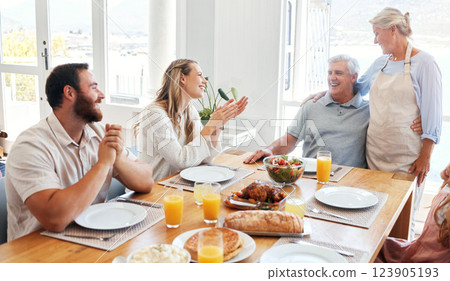 Food, relax and happy with family at table for lunch, love and smile together in dining room. Eating, holiday and dinner for celebration with couple and parents for retirement, peace and lifestyle 123905193