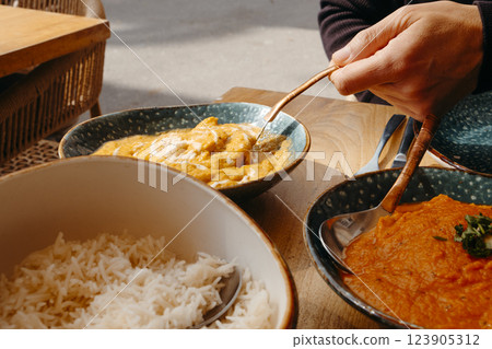 man serving some chicken korma 123905312