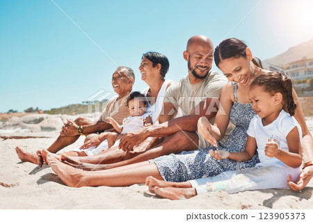 Happy, family and relax with smile on beach for summer vacation and bonding time together in nature. Mother, father and grandparents with children relaxing on sandy shore smiling for holiday travel 123905373