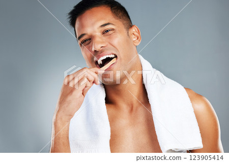 Man, toothbrush and teeth for dental hygiene in clean, fresh and wash for healthcare against a grey studio background. Portrait of a toothy male brushing mouth for oral and gum care treatment Man, toothbrush and teeth for dental hygiene in clean, fresh and wash for healthcare against a grey studio background. Portrait of a toothy male brushing mouth for oral and gum care treatment 123905414