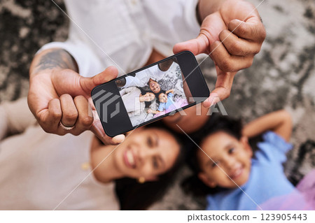 Family, hands and phone for selfie photo relaxing on the floor with smile for fun, bonding and moments together. Hand of happy father, mother and child smiling for picture perfect image on smartphone Family, hands and phone for selfie photo relaxing on the floor with smile for fun, bonding and moments together. Hand of happy father, mother and child smiling for picture perfect image on smartphone 123905443