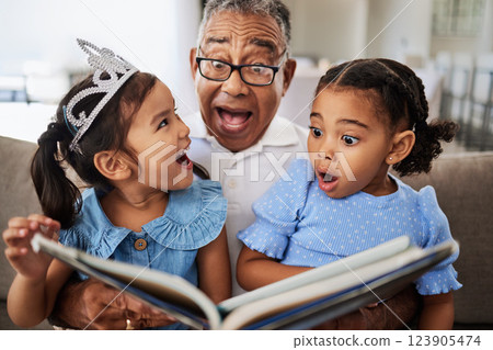 Family, reading book and children with grandpa for wow, surprised and excited expression in a living room with people bonding. Grandfather or man, kids and story time at home with man and girls Family, reading book and children with grandpa for wow, surprised and excited expression in a living room with people bonding. Grandfather or man, kids and story time at home with man and girls 123905474