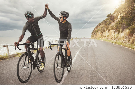 Bike, friends and men high five on road having fun cycling together outdoors. Success, diversity and teamwork of male cyclists on bicycles riding on street, exercise or workout training on asphalt. Bike, friends and men high five on road having fun cycling together outdoors. Success, diversity and teamwork of male cyclists on bicycles riding on street, exercise or workout training on asphalt. 123905559