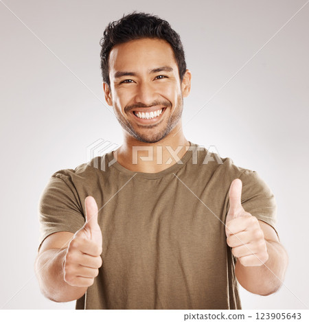 Man, happy and portrait with thumbs up in studio for support, agreement and positive review of promotion. Success, person and like emoji on gray background for sale approval, yes sign and thank you Man, happy and portrait with thumbs up in studio for support, agreement and positive review of promotion. Success, person and like emoji on gray background for sale approval, yes sign and thank you 123905643