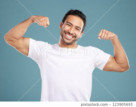 Fitness, man and strong arms in studio with muscle progress, healthy body and workout results. Bodybuilder, portrait and athlete flexing biceps with power, strength and confidence on blue background Fitness, man and strong arms in studio with muscle progress, healthy body and workout results. Bodybuilder, portrait and athlete flexing biceps with power, strength and confidence on blue background 123905693