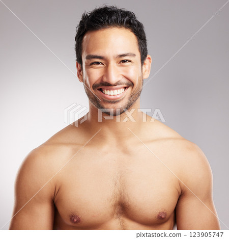 Skincare, portrait and smile of man in studio for natural cosmetics or dermatology routine. Aesthetic, shirtless and beauty with happy model on gray background for cosmetology or satisfaction 123905747