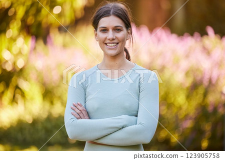 Smile, fitness and woman training in nature for health, cardio and morning motivation. Portrait of young, happy and calm athlete with arms crossed, pride in workout and wellness journey with exercise 123905758