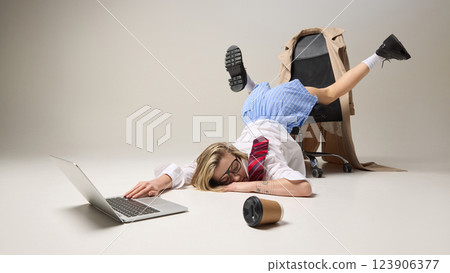 Exhausted woman collapsed in unconventional pose on office chair against white background, and sleeping, conveying stress and work-induced fatigue. 123906377