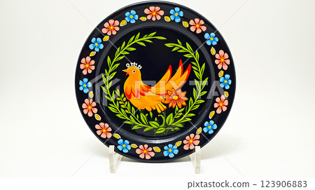 Decorative ceramic plate featuring a colorful bird and floral design, showcasing craftsmanship and art style from traditional culture Decorative ceramic plate featuring a colorful bird and floral design, showcasing craftsmanship and art style from traditional culture 123906883