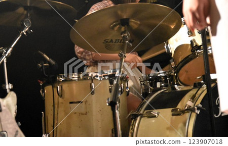 A female drummer playing the drums A female drummer playing the drums 123907018