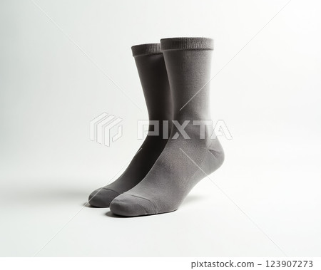 Gray cotton socks positioned evenly on a neutral background highlighting texture and simplicity in minimalist design Gray cotton socks positioned evenly on a neutral background highlighting texture and simplicity in minimalist design 123907273