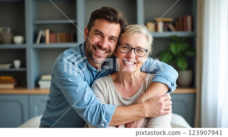 Emotional moment between a son and his mother in a cozy living room filled with warmth and love 123907941
