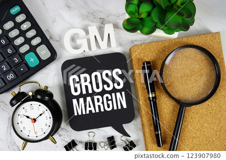 GM - Gross Margin acronym with calculator, alarm clock and magnifying glass, Business concept background GM - Gross Margin acronym with calculator, alarm clock and magnifying glass, Business concept background 123907980