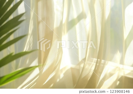 transparent curtain on the window, gently moved by the wind. sunlight. sun's rays shine through the transparent tulle transparent curtain on the window, gently moved by the wind. sunlight. sun's rays shine through the transparent tulle 123908146