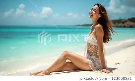 Woman enjoying a sunny day on a tropical beach with turquoise water and sandy shore 123908521