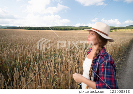 Woman in a Wheat Field, Looking Out at the Horizon 123908818