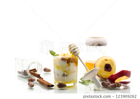 sweet homemade yogurt in a glass with apples, nuts and honey 123909262
