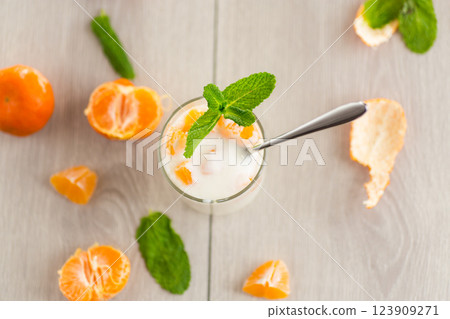 Milk dessert with tangerine pieces 123909271