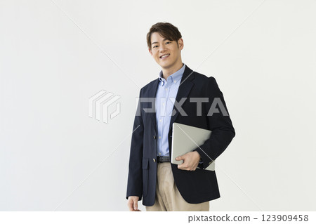 A businessman in his 30s with a laptop A businessman in his 30s with a laptop 123909458