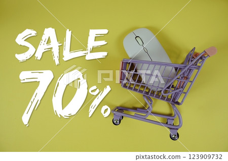 Sale 70% Special Discount shopping online with trolley shopping cart and optical mouse on yellow background 123909732