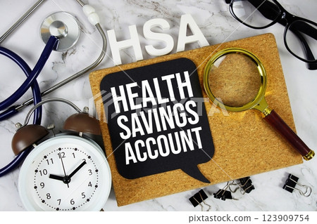 HSA - Health Savings Account acronym with alarm stethoscope, alarm clock and magnifying glass, medical and healthcare concept background HSA - Health Savings Account acronym with alarm stethoscope, alarm clock and magnifying glass, medical and healthcare concept background 123909754