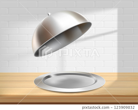 Tray dish with metal cap cloche on wooden tabletop 123909832