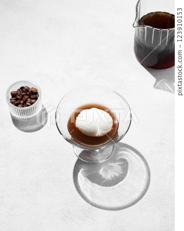 Affogato coffee with a scoop of vanilla ice cream and espresso in a glass on a light background Affogato coffee with a scoop of vanilla ice cream and espresso in a glass on a light background 123910153