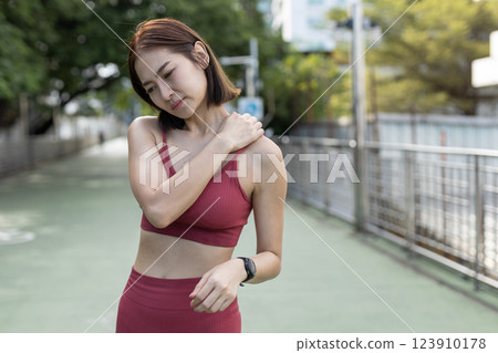 women red sportswear standing problem neck, shoulder and back painful after exercise. female bone injuries pain. discomfort sprain orthopedic. 123910178