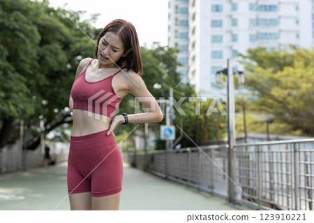 women red sportswear standing problem backache painful after exercise. female lower back pain. discomfort sprain orthopedic. women red sportswear standing problem backache painful after exercise. female lower back pain. discomfort sprain orthopedic. 123910221
