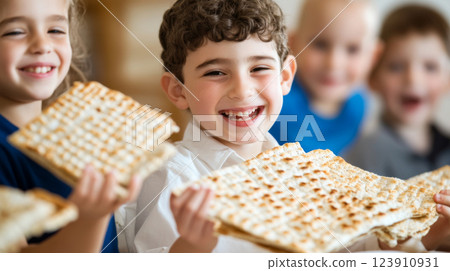 Passover celebration with three smiling children enjoying matzah 123910931