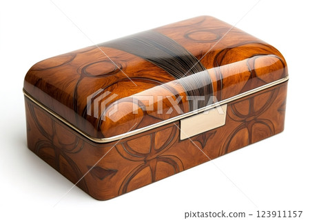 Lacquered wooden box with golden metal inserts featuring abstract decorations is lying on white background 123911157