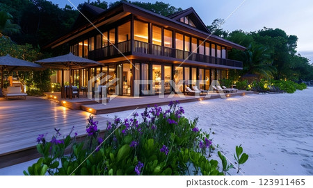 Luxurious beach villa illuminating the tropical twilight on North Island, Seychelles 123911465