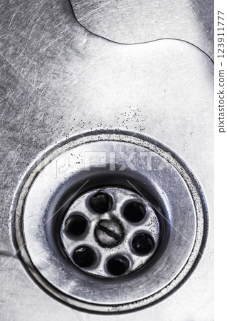 Drain hole in the kitchen sink Drain hole in the kitchen sink 123911777