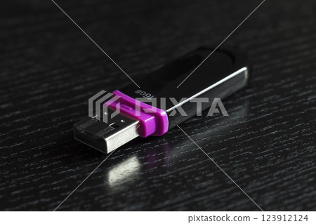 USB flash drive on a black office desk USB flash drive on a black office desk 123912124